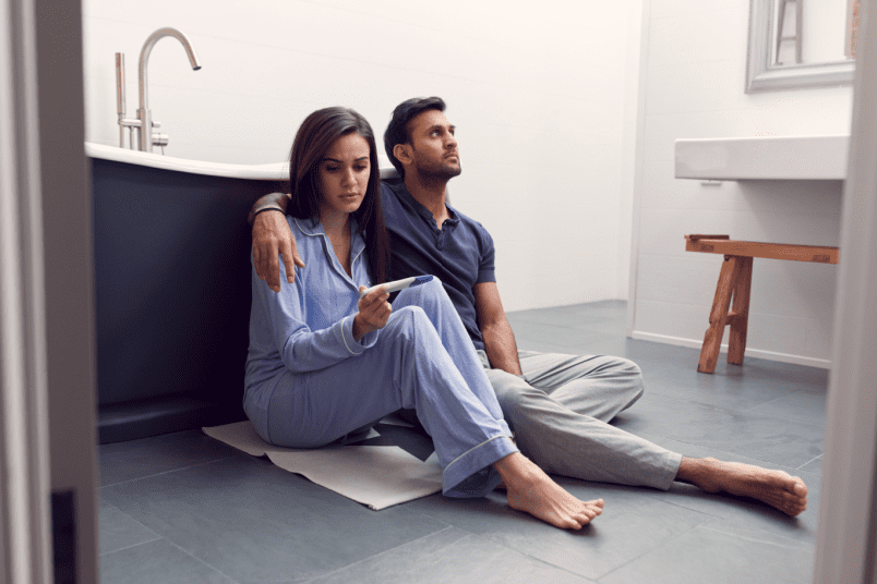 Disappointed Couple Sitting on The Floor - NU Fertility