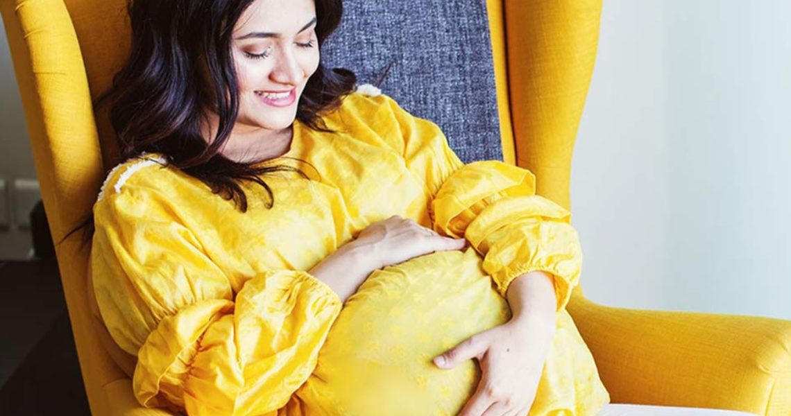 Pregnant Woman Lying on the Couch - NU Fertility